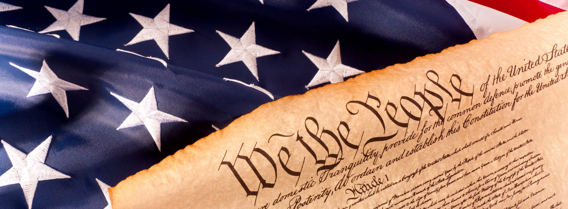 The United States Constitution against the American flag.