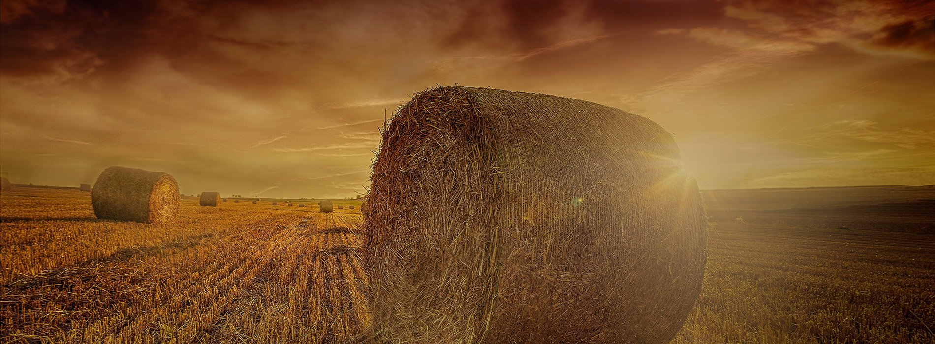 Gloriously dark sky with large bale in front. Photo by Luca Huter on Unsplash