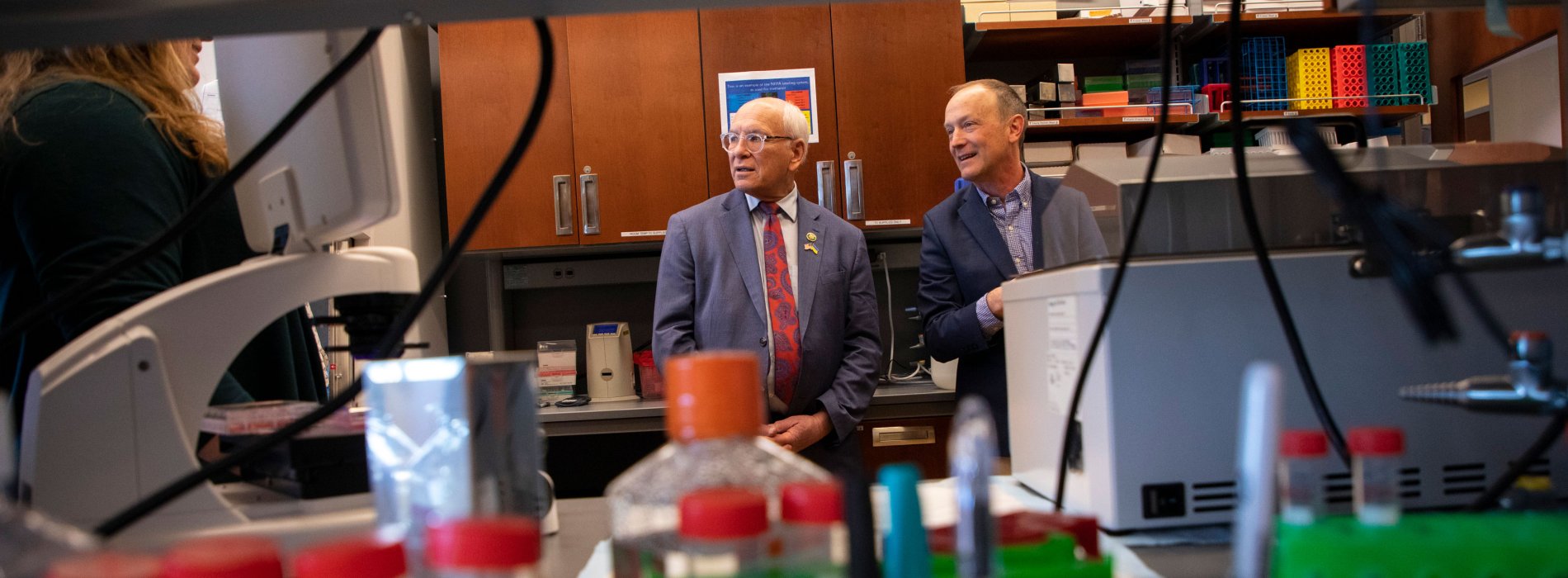 Representative Paul D. Tonko stands inside a laboratory with a UAlbany researcher.