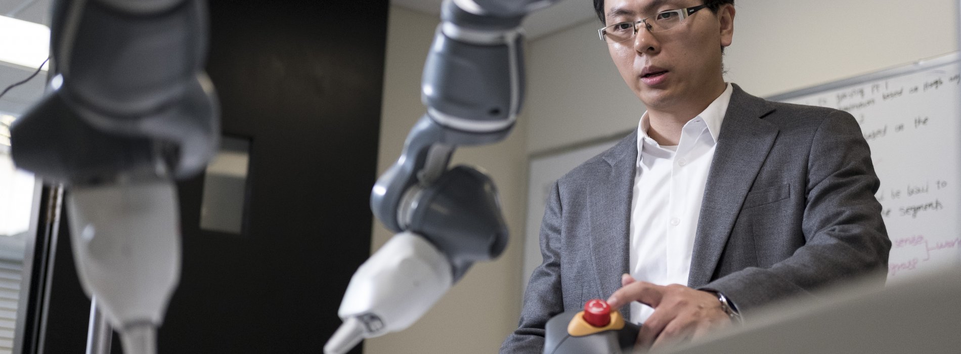 ECE assistant professor Weifu Wang  conducting robotics research