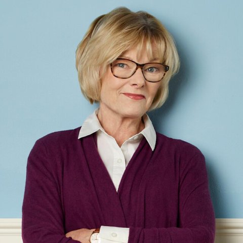 Actress Jane Curtin smiling in front of a blue background