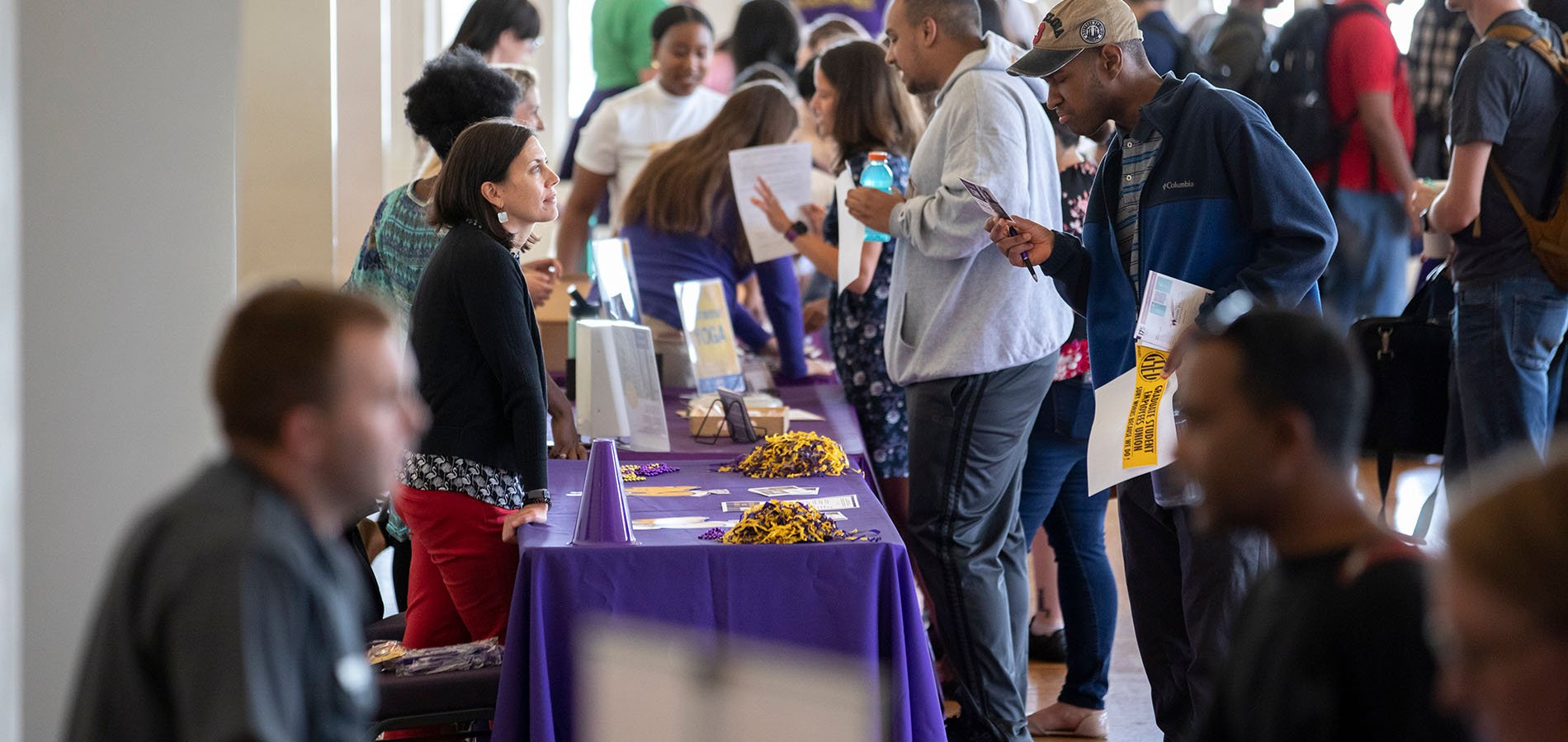Students engaging in conversation at Graduate Student Resource Fair