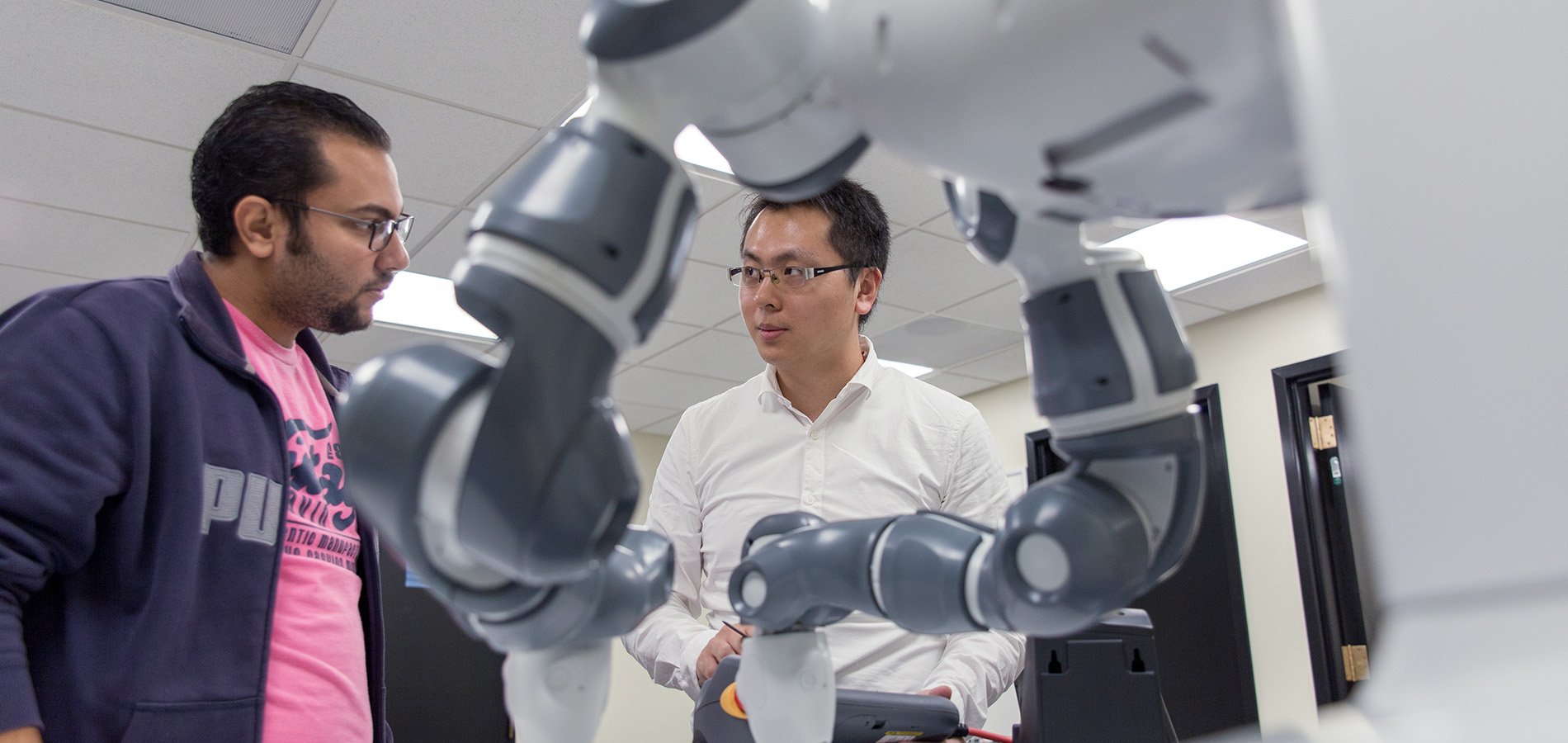 ece professor and student conducting robotics research in lab