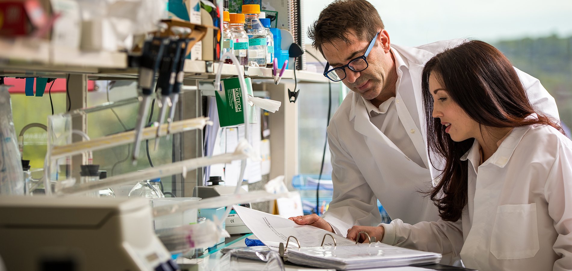 Scientific Research being conducted in a laboratory by a student and a professor