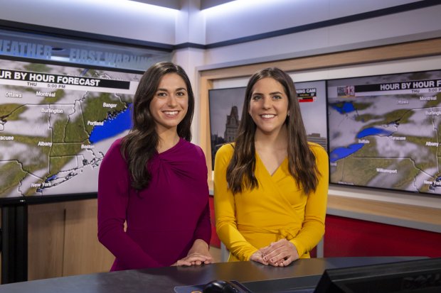 Two interns pose for a photo on the set of WNYT's weather broadcast