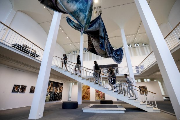 People walking up the stairs in the museum