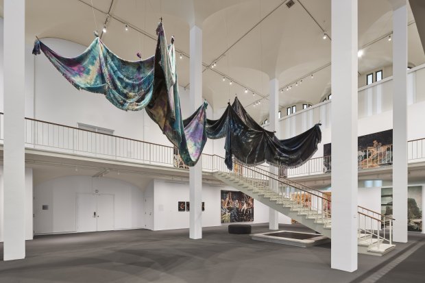Large shrouds hanging from the ceiling of the museum