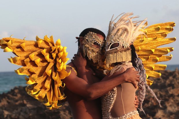 Two figures in festive dress and masks