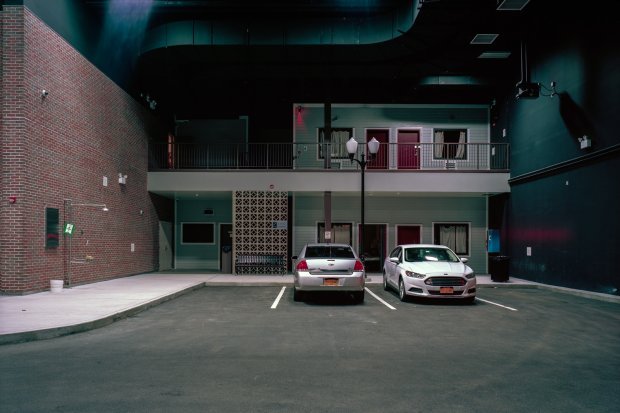 Cars parked in front of a false motel set