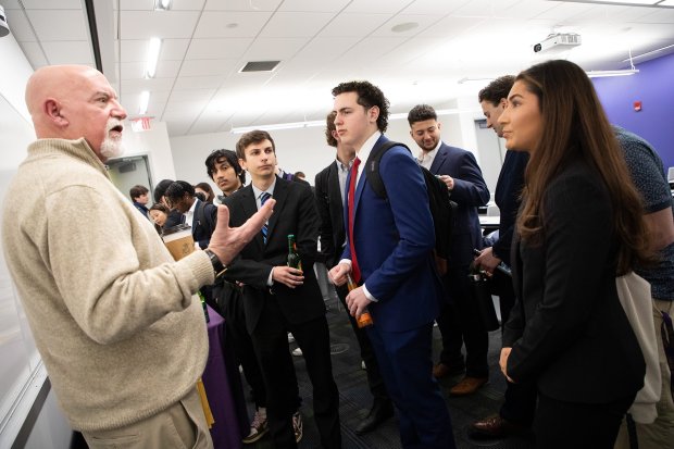 Norm speaking to a group of students