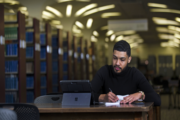 Student studying in the library on campus