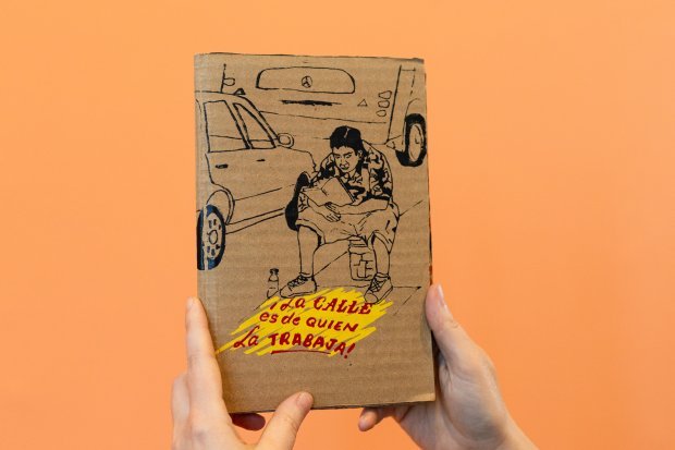 Hand holding small press publication