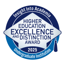 A blue circular logo with a gray graduation cap and the words “Insight into Academia, Higher Education Excellence and Distinction Award 2025, Undergraduate Institution.”