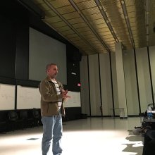 Glen Trotiner stands on stage at UAlbany Filmmaking from Script to Screen event