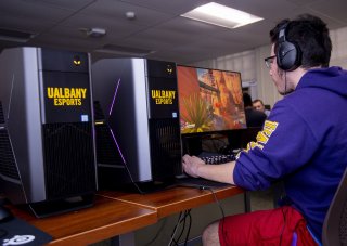 Photo of a UAlbany eSports student in the competitive gaming arena at Draper Hall.