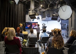 Members of the OCM team give a media training presentation from inside UAlbany's digital media studio.