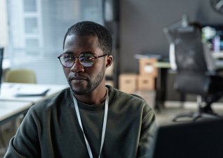 A cybersecurity analyst works in an office.