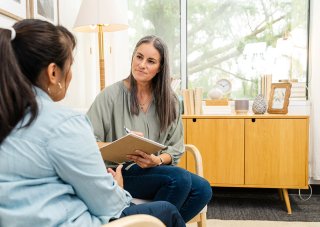 A counselor works with a client in her office.