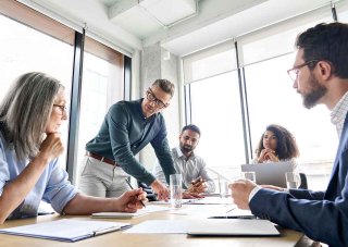 A digital marketing team meets around a conference table.
