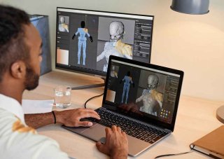 A 3D game artist develops a character on a laptop.