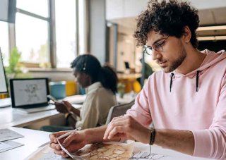Video game designers work on a new game in a shared office space.