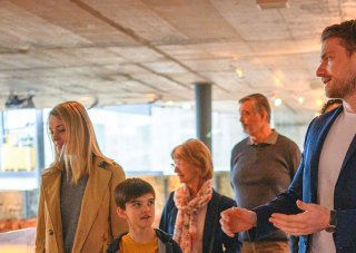 A historian leads a group through a museum exhibit.
