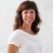Dr. Deborah Schussler smiling brown hair white shirt white background