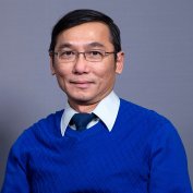 Dr. Tran smiles at the camera.