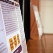 Research posters from the AI & Writing Fair on easels. 
