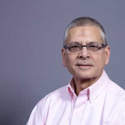 Dr. Khwaja smiles at the camera.