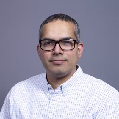 Dr. Banavali smiles at the camera.