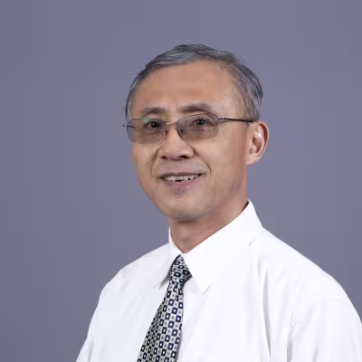 Dr. Shijun Lu smiles at the camera.