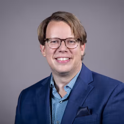 Brian Freidenberg, white man with sandy brown hair and brown eyes, with an inviting smile.