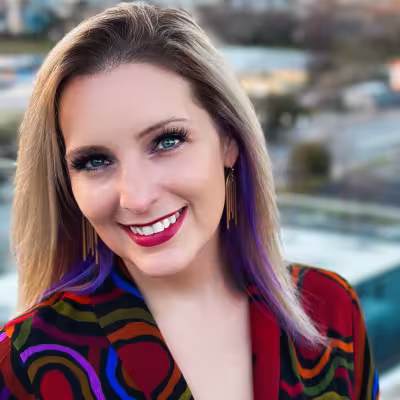 Dr. Melanie Wilcox smiling outside in colorful jacket