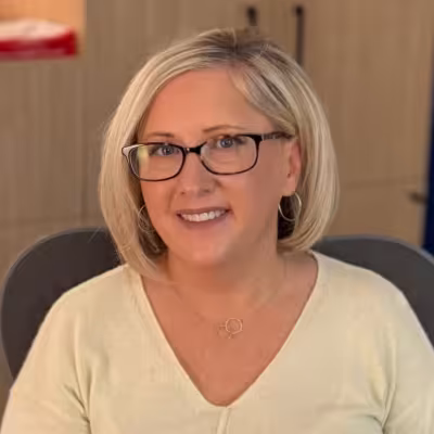 individual with glasses and blonde hair smiling