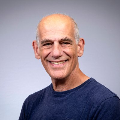 William smiles at the camera.