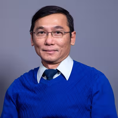 Dr. Tran smiles at the camera.