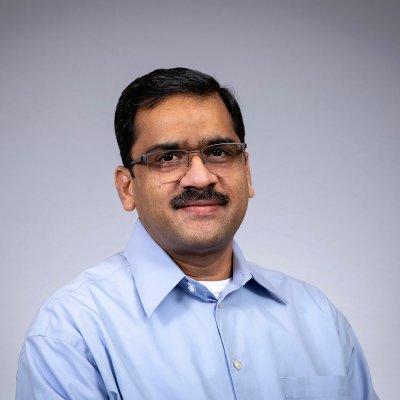 Rajendra smiles at the camera.