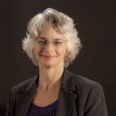 Dr. Heidi L. Andrade smiling with black background