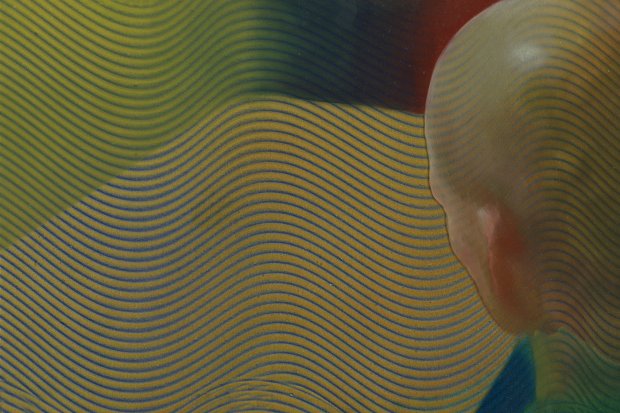 Bald head figure on a wavy geometric background