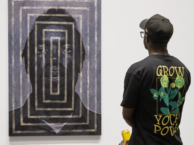 Visitor standing in front of painting