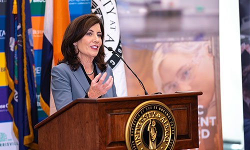 Governor Hochul stands behind a podium as she delivers a speech at the SUNY AI Symposium