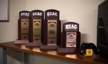 ECAC trophies lined up inside of UAlbany's competitive video gaming arena.