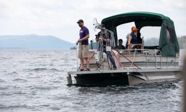 ASRC researchers ride a pontoon boat on Lake George that is used to monitor air-sea interactions close to the surface. 