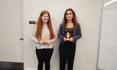 Bailey Vooris and Lauren Liberti proudly display their "Dane Bot" awards.