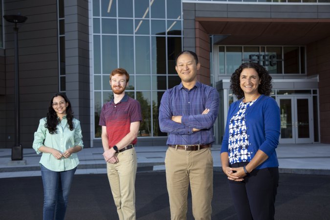 NSF project leaders, including both students, stand in front of the ETEC building.