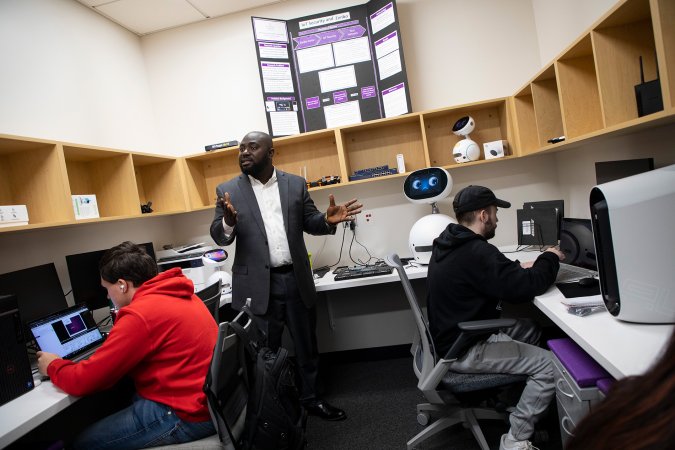Benjamin Yankson stands with students in the Hack-IoT lab at ETEC.