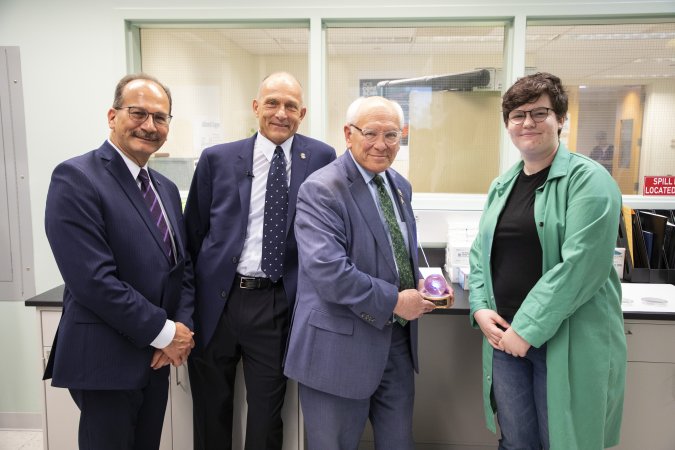 President Rodriguez, Distinguished Professor of Chemistry Igor Lednev, Congressman Tonko and a UAlbany student researcher stand together for a photo inside the Lednev lab. 