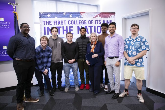 Sen. Gillibrand poses with students at Friday's press conference.