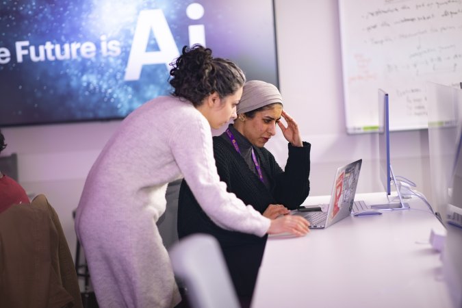 Graduate student researchers Mahsa Goodarzi and Rawan AlMakinah work together at CEHC’s AI in Complex Systems Lab.